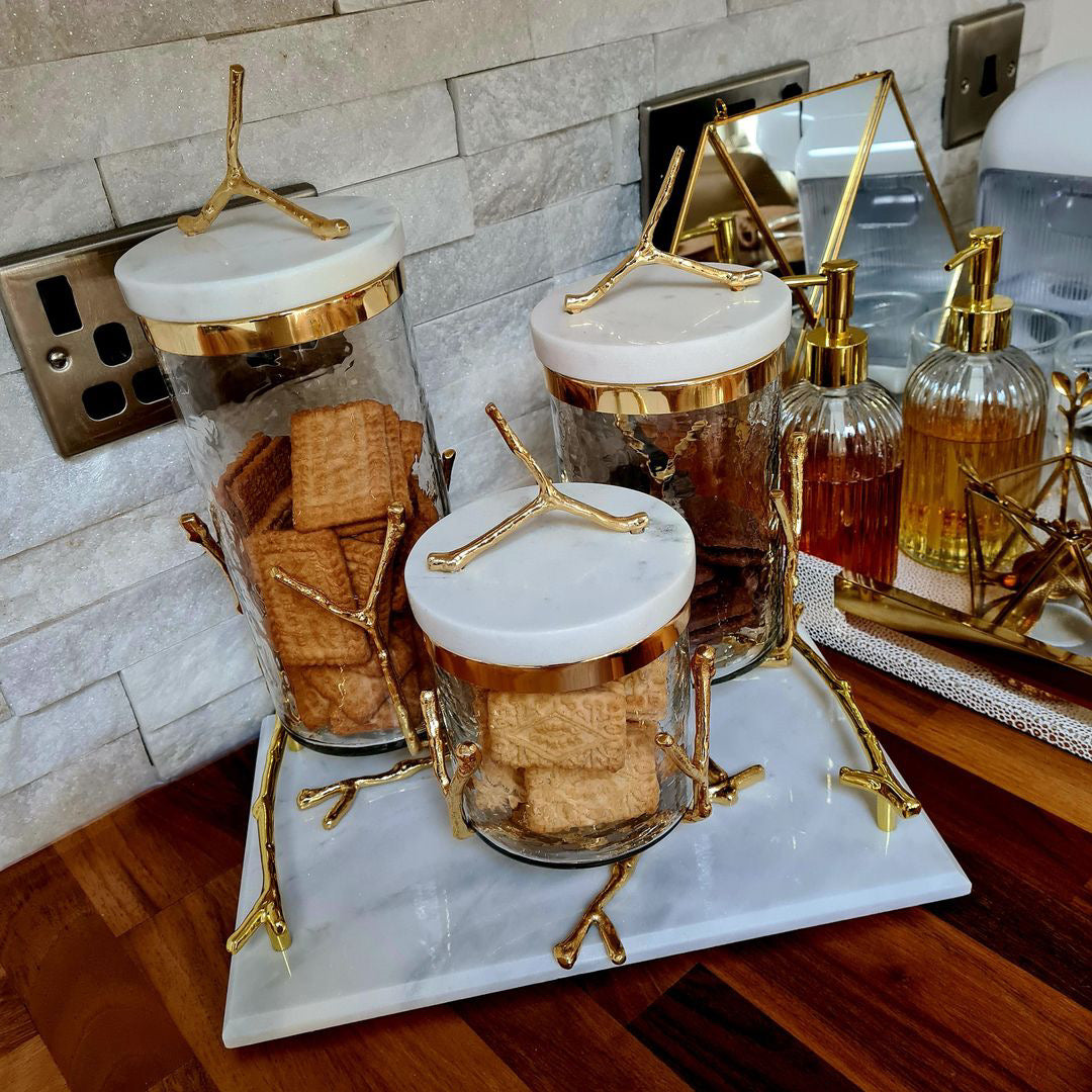set of 3 gold and white marble canisters on marble tray 