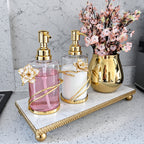 Gold glass soap and lotion dispenser set on marble tray | High Class Touch